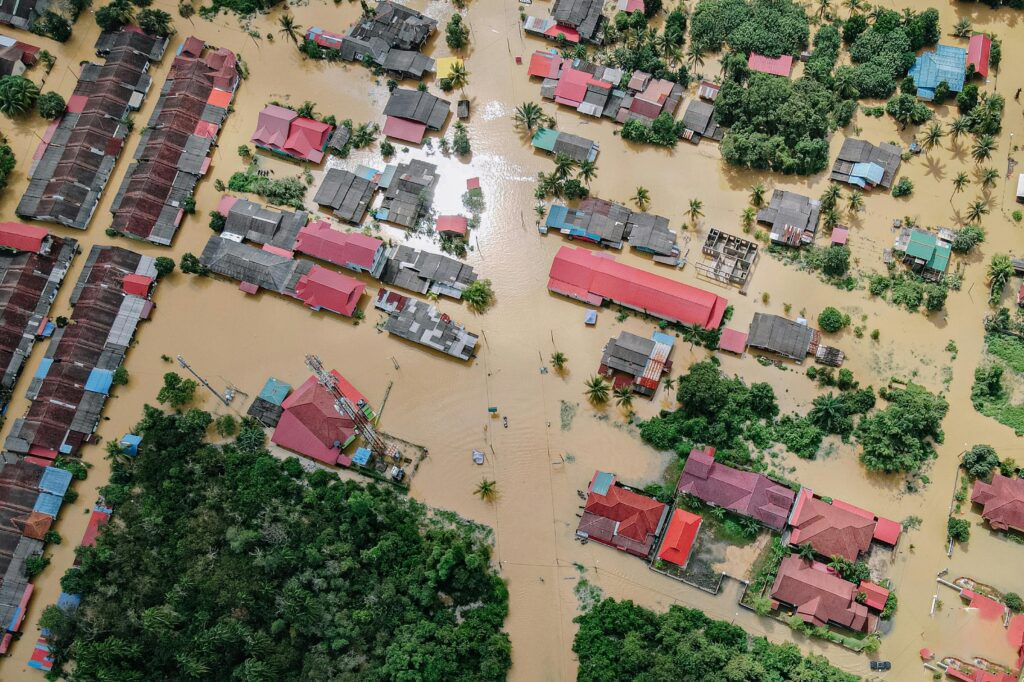 Aerial floodplain footage - Houses and trees in flood water